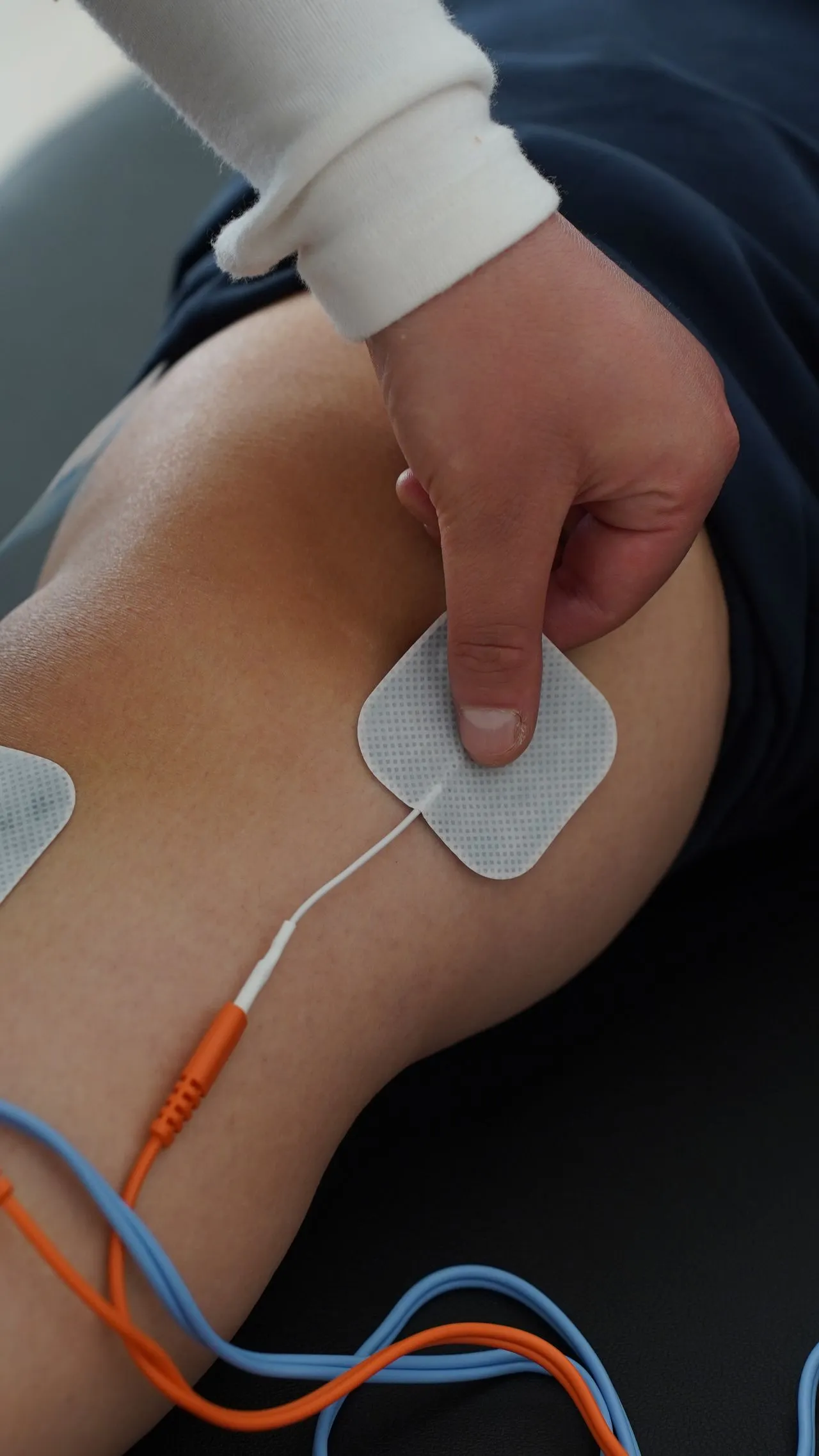 Electrical stimulation pads placed on a patient’s knee
